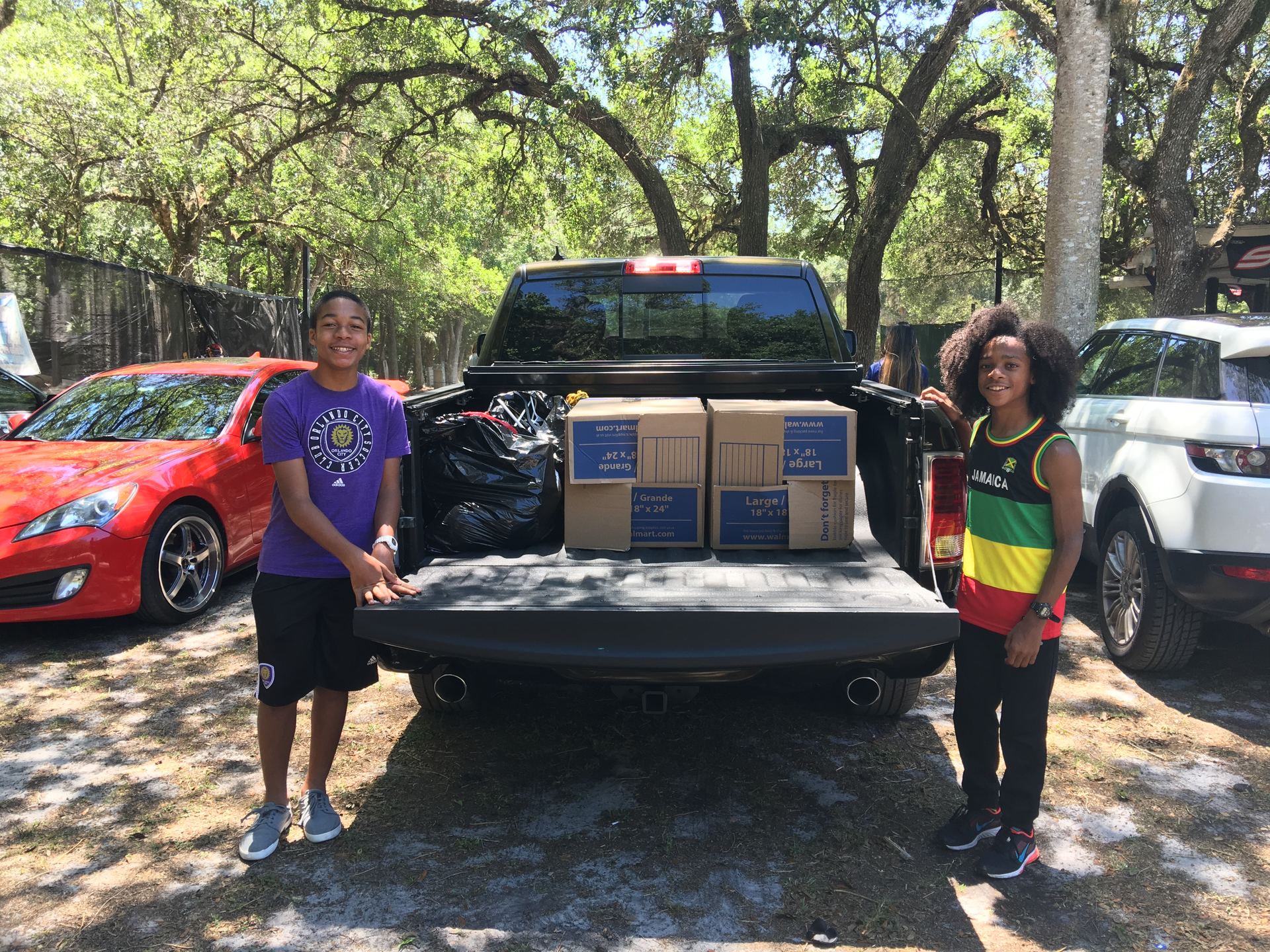 Volunteers loading donated clothing boxes into a truck for the Bithlo clothing drive