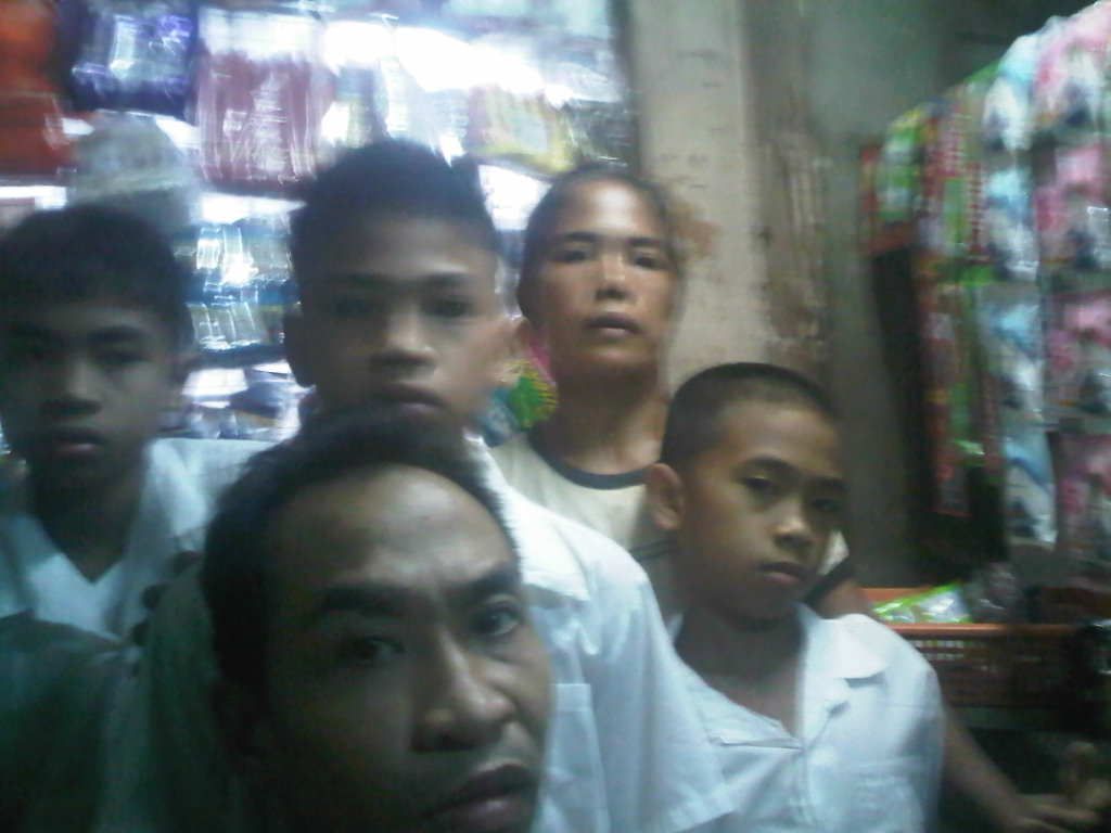 Danilo and his family inside their sari-sari store in Manila